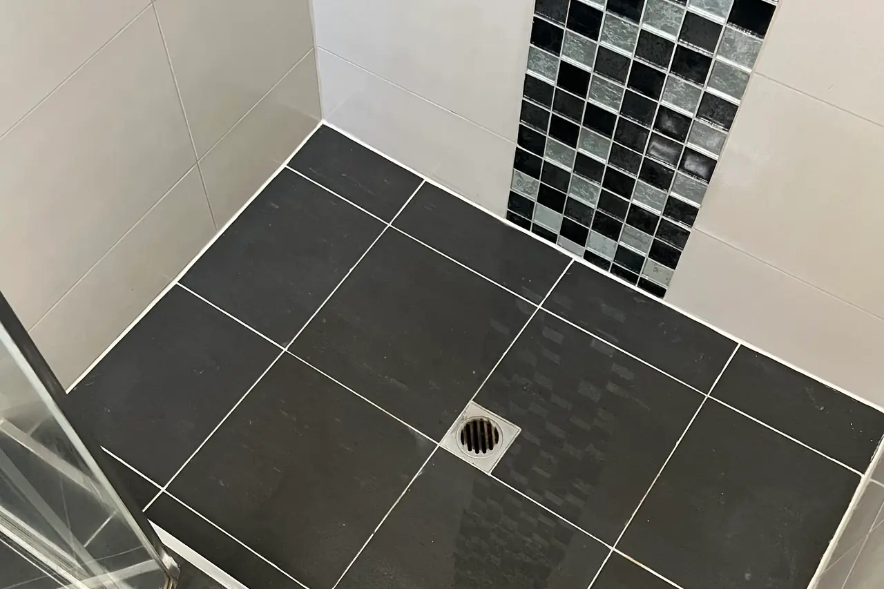 Same shower floor and corner with the grout cleaned and resealed