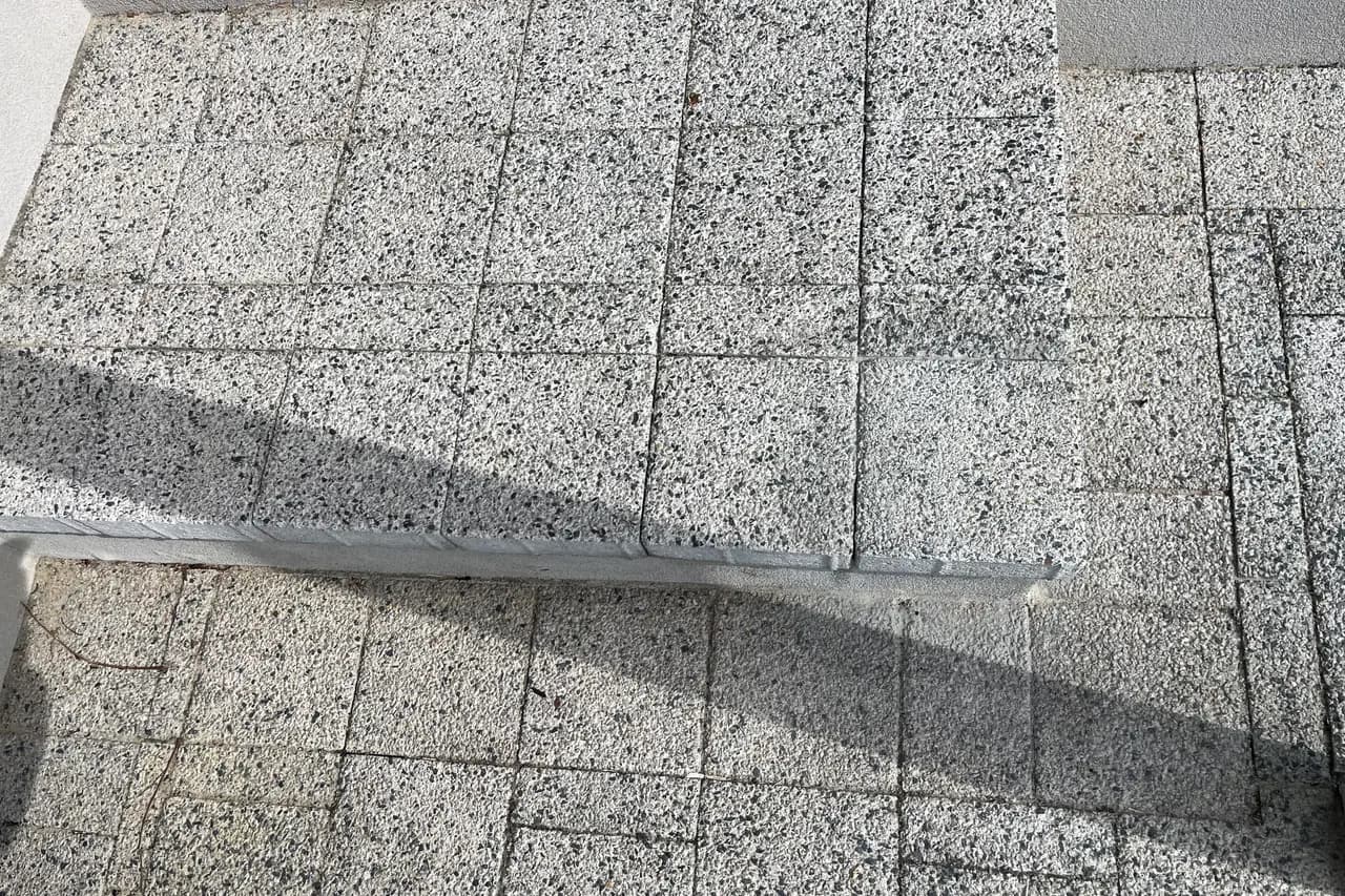 Same exterior entry step with the corner tile refitted and flush